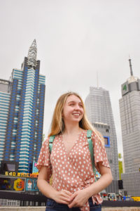 girl poses in front of lego new York city skyline at legoland New York resort